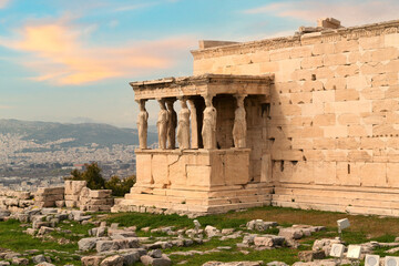 Erechtheion Temple (or Erechtheum) with the figures of Caryatids at the archaeological site of Acropolis in Athens, Greece at sunset. It was dedicated to both Athena and Poseidon. Golden soft light