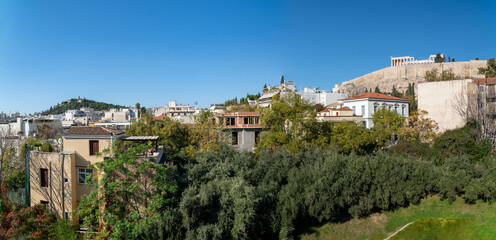 Panoramic view to the Acropolis of Athens with Parthenon all the way to Filopappou Hill as seen from the cafe ofscenic the new Acropolis museum. Sunny day, clear blue sky