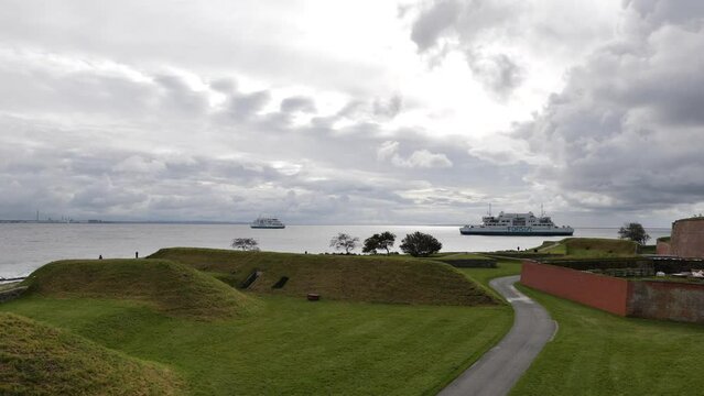 Outdoor scenery from Kronborg Slot and background of north sea with Ferry ship from Forsea Company sail and cloudy sky.