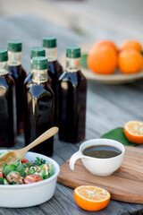Pomegranate molasses in small bowl. Pomegranate sweet and sour syrup with pomegranate fruit and seeds.