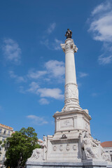 Fototapeta premium A huge white stone column with a bronze statue of a king of Portugal Pedro IV at the top, Rossio Square, Lisbon, Portugal