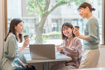 休憩でパソコンを見ながら雑談するol・同僚・友達・ビジネスウーマン・女性（アジア人・中国人・日本人）
