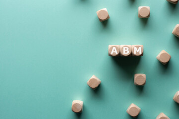 There is wood cubes with the word ABM. It's an abbreviation for Account Based Marketing.