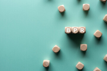 There is wood cubes with the word BPR. It's an abbreviation for Business Process Re-engineering.