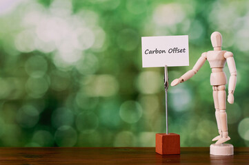 There is a piece of paper with the word Carbon Offset. It is eye-catching image.