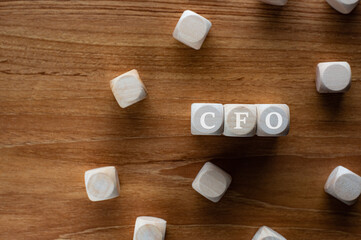 Fototapeta na wymiar There is wood cubes with the word CFO. It's an abbreviation for Chief Financial Officer.