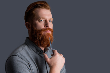 man hairdressing with barber scissors, copy space. barber man in hairdresser studio. barber man