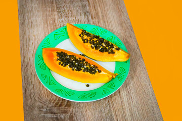 Fresh ripe papaya fruits on wooden table. sliced papaya 