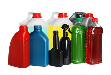 Many bottles and canisters with liquids on white background