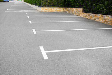 Empty outdoor parking lot with painted markings on asphalt