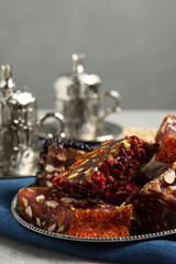 Tea and Turkish delight served in vintage tea set on grey table, closeup. Space for text
