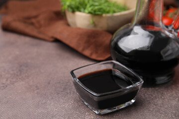 Organic balsamic vinegar on grey table, closeup. Space for text