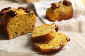 Delicious pumpkin bread with pecan nuts on tablecloth, closeup