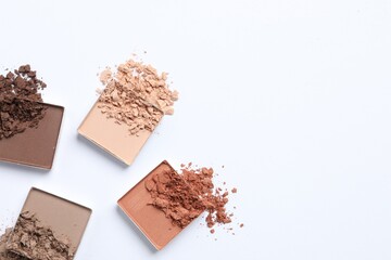 Crushed eye shadows on white background, flat lay with space for text. Professional makeup product