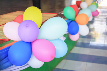 Fototapeta na wymiar Colorful balloons decorating on side of stage in activity day for being good vibe in the day