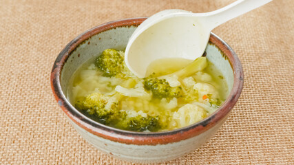 Serving soup. Cauliflower broccoli soup in a bowl close-up on a table