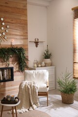 Beautiful room decorated for Christmas with potted firs. Interior design
