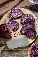 Tray with slices of fresh red cabbage on wooden table, flat lay