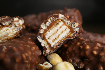Tasty chocolate bars with caramel and nuts, closeup