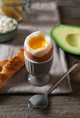 Soft boiled egg served for breakfast on wooden table