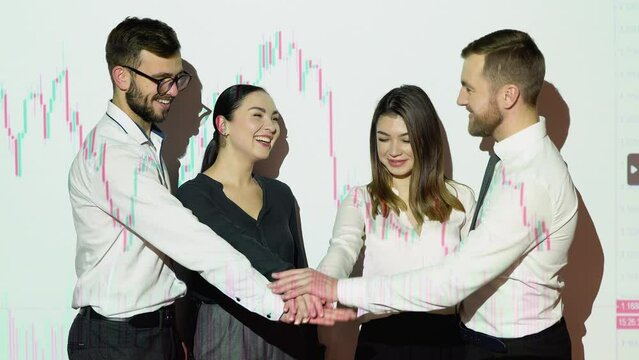 Corporate business team people group stacks hands together in pile with cryptocurrency chart on background. Leadership and teamwork spirit concept