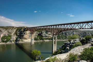 Fototapeta na wymiar High Steel Bridge Over a Green River