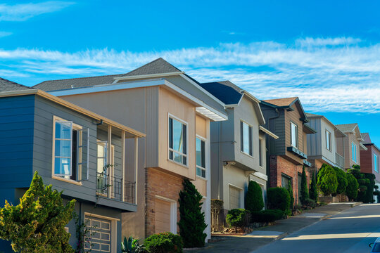 Row of colorful houses in the historic districts of downtown san francisco california in midday shade partly cloudy sky