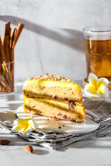 a piece of carrot cake with tea