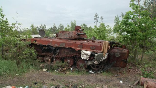 March, 2022. Irpin, Ukraine. Russian military engines in the village near Kyiv, Ukraine. Burnt and broken tank remains in suburbs of occupied town. High quality 4k footage