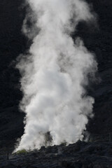 A plume of smoke rising from a volcanic vent