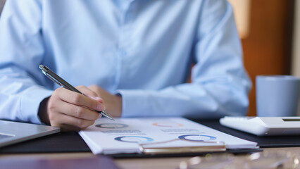 Fototapeta premium Business concept, Businesswomen reading financial data and writing notes in document at workplace