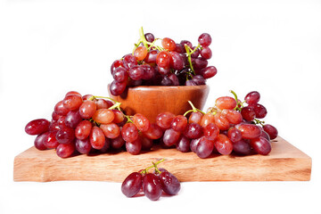 bunch of red seedless grapes on a white background