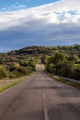 Fototapeta premium Scenic Road near a town by the Sea. Costa Rei, Sardinia, Italy. Sunny Cloudy Day.