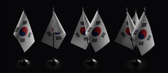 Small national flags of the South Korean on a black background