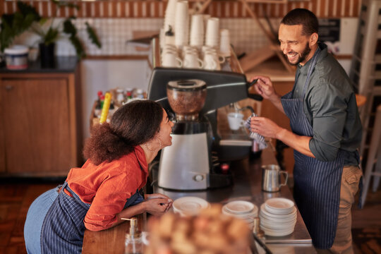 Coffee, cafe and barista couple laughing at funny meme, joke or comedy. Small business owners, waiters and diversity of happy man and woman working in restaurant while talking or comic conversation.