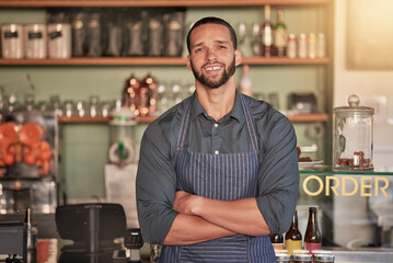 Portrait, cafe and barista man with arms crossed ready to take your order. Coffee shop, waiter and confident, happy and proud young male employee from Brazil or small business owner of cafeteria.