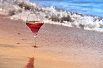 Wine glass with a cocktail by the sea.