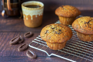 freshly baked homemade banana chocolate muffins on wooden table background.