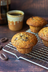 freshly baked homemade banana chocolate muffins on wooden table background.