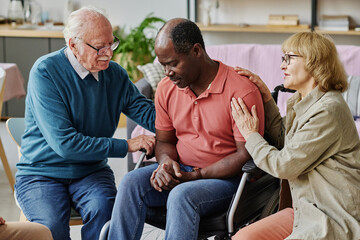 Obraz premium Senior people supporting their friend with disability while he worried about his disease