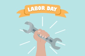 hand with wrench and labor day text