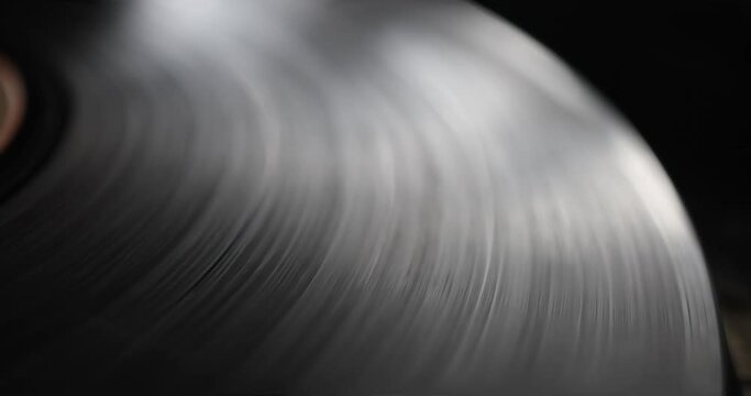 Retro-styled spinning record vinyl player. Close up. Rotating vintage 