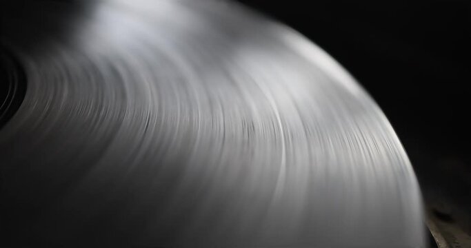 Retro-styled spinning record vinyl player. Close up. Rotating vintage 