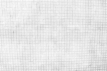 Old white ceramic small tile with squares seamless patterns on background