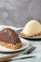 Chocolate Banana Cake. Malaga cake with banana inside, chocolate and hazelnut outside on a stone background. close up