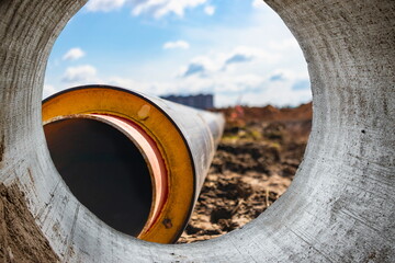 Insulated pipe. Large metal pipes with a plastic sheath at a construction site. Modern pipeline for...