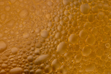 Ladle soup in yellow orange soup