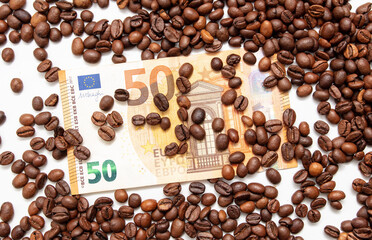 Coffee grains with fifty Euro on a white background.