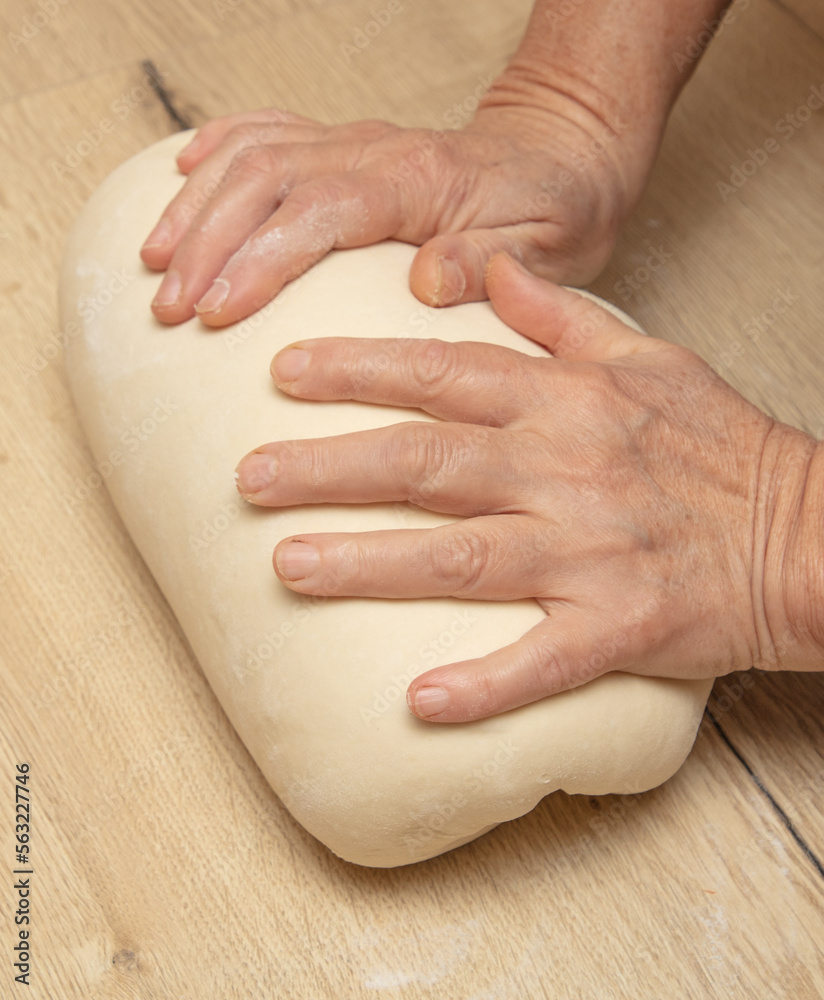 Wall mural Hand kneading flour dough.