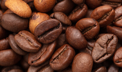 Grains of black coffee as a background.